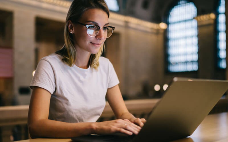 Woman working remote with laptop device