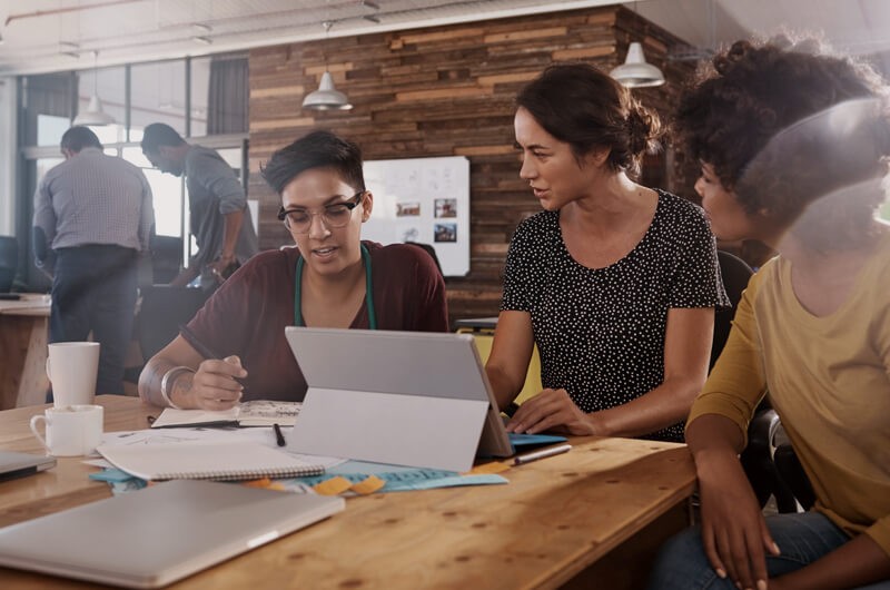 Business team talking around modern community desk seating