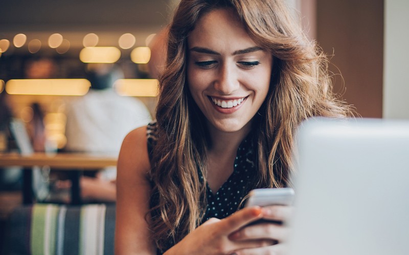 Smiling client using chat to check on product ordering status