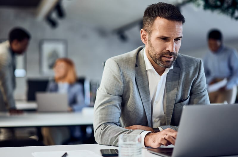 Simplify device as a service Businessman on laptop computer in office, Insight Flex for Devices, MDaaS