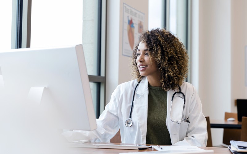 Doctor using laptop computer