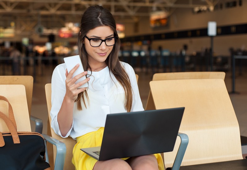 Businesswoman working from an airport travel hotspot 