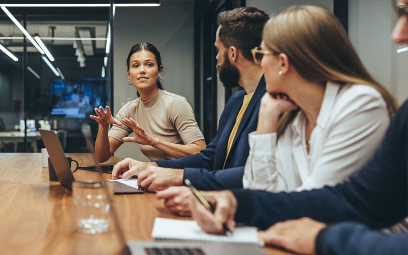 Business professionals listening to strategy and development presentation
