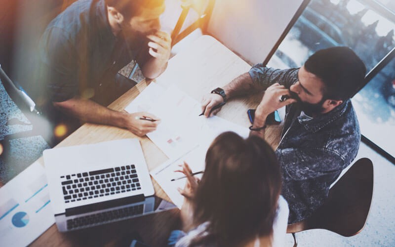 Group gathers around reviewing assessment results